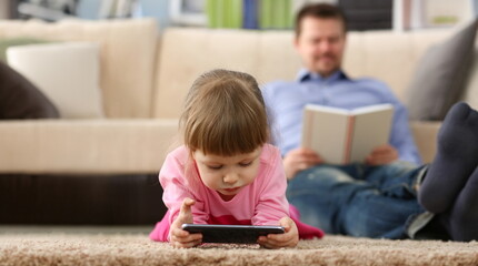 Portrait of little girl kid watching cartoon on smartphone device, digital entertainment for child. Funny pastime on holiday. Play and childhood concept