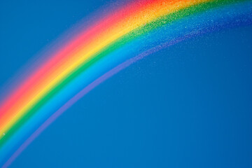 rainbow in blue clear sky with clouds after the rain