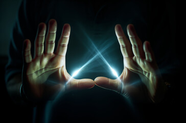 Hands Creating a Magical Light Effect in the Dark, Symbolizing Energy and Mystery