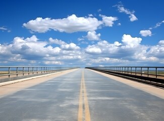 Asphalt road under blue sky with white clouds, perspective view.