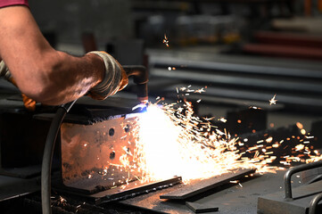 Workers who perform welding and laser cutting on metal