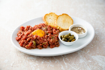 Traditional steak tartare with egg yolk