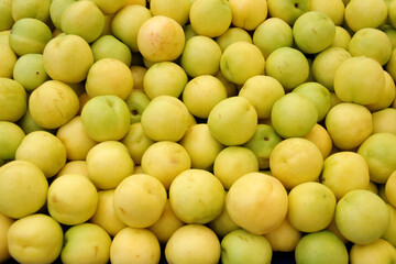Yellow peach fruit on the market stall. Yellow nectarine fruit.