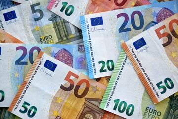 Many european euro money bills in chaotic arrangement. Pile of eur banknotes with different colors and condition