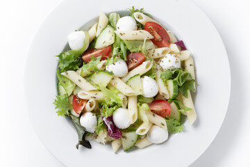 Pasta salad with vegetables and mozzarella cheese isolated on white background