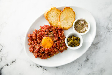 Traditional steak tartare with egg yolk