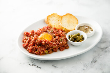 Traditional steak tartare with egg yolk