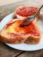 Slice toast bread with strawberry jam and butter