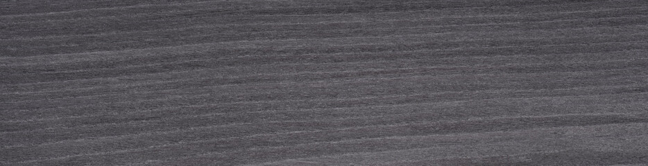 Swirls of charcoal grey and soft black elegantly dance across the muted ash wood veneer, offering a modern and sophisticated look