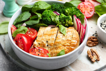 Healthy meal. Delicious chicken, vegetables and spinach in bowl on table, closeup