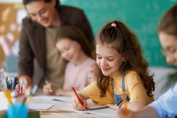 Happy kids and teacher at school