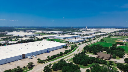 Fototapeta premium Industrial zone on suburb with basketball field park, suburban houses and large fulfilment center logistic complex, modern warehouse, shipping container load unload semi-trailer truck, Texas