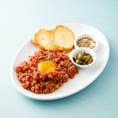Traditional steak tartare with egg yolk