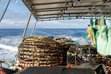 wooden crayfish pots trap on a fishing boat out at sea catching fish