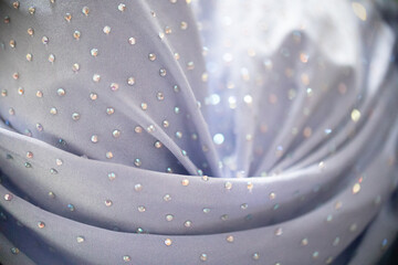 A closeup of rhinestone fabric on a blue prom dress © Erin Cadigan