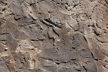 Rough cement plaster texture. The wall is made of concrete and has a grey color