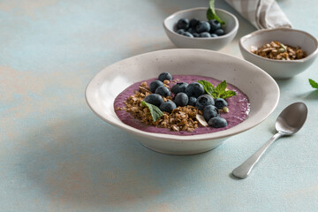 Healthy summer smoothie bowl with blueberries and granola