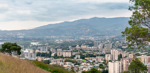 View of the Georgian city of Tbilisi from the side of the sculptural composition Chronicle of Georgia. Aerial view of houses and mountains in Tbilisi, Georgia.