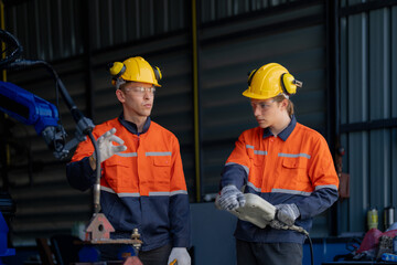 engineers check control heavy machine robot arm. Diverse Team of Industrial Robotics Engineers Gathered Around Machine. Professional Machinery Operators repair electric robot on bright digital panel.