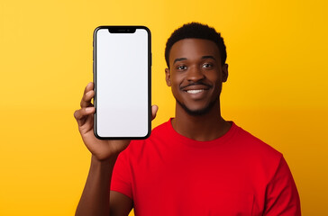Smiling man holding a smartphone with a blank screen, standing against a bright yellow background, showcasing modern technology and connectivity