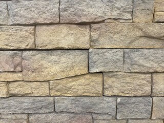 Brick wall texture, closeup of an old exterior surface as a background. Building face wall, convex joint line between dissimilar faded bricks brings character and dimensionality to vintage masonry.