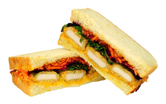 katsu sando sandwiches, filled with panko breaded chicken, katsu mayo and pickled cabbage isolated on a white background