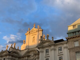 Façade of Kirche am Hof, Wien / Church am Hof Square, Vienna the early evening sun in summer with a blue sky with a few clouds