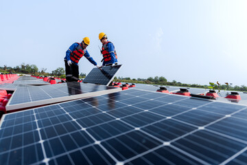 Male workers repair Floating solar panels on water lake. Engineers construct on site Floating solar panels at sun light. clean energy for future living. Industrial Renewable energy of green power.