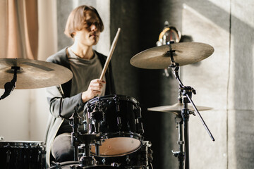 Fototapeta premium Young Drummer Practicing on Drum Kit. 