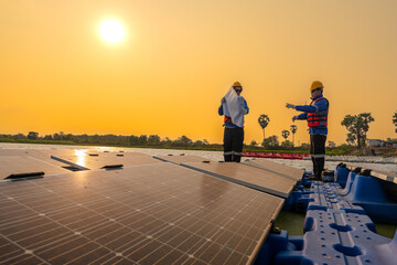 Photovoltaic engineers work on floating photovoltaics. workers Inspect and repair the solar panel equipment floating on water. Engineer working setup Floating solar panels Platform system on the lake.