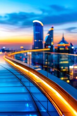 Fototapeta premium modern cityscape view from rooftop deck with glass railing and blurred lights at sunset.