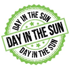 DAY IN THE SUN text on green-black round stamp sign