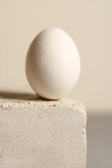 a large white egg on a concrete corner