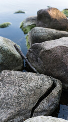 A cracked stone on the lake shore. Stone Wild Coast