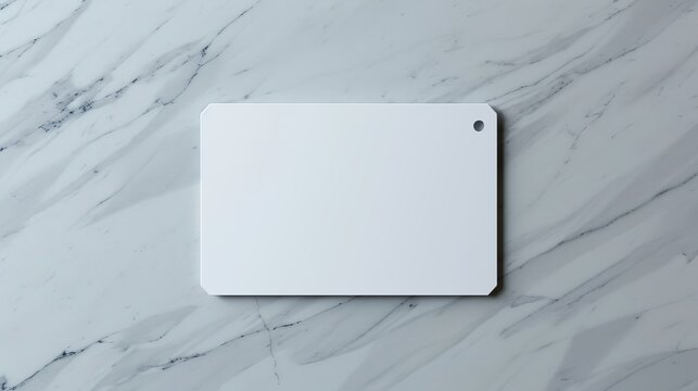 A hyperrealistic depiction of a blank ID card mockup. The card is made of smooth, white plastic with a rounded rectangle design. A faint shadow suggests a small hole punched near the top.