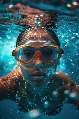 Fototapeta premium Close-up underwater photograph capturing a person swimming with orange goggles, creating a dynamic and refreshing view with bubbles and vibrant blue water