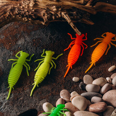 silicone trout fishing lures lie on the rocks