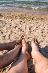 A gay couple relaxes at the seaside in the summer. Love and romantic relationships.