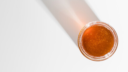 Fresh golden honey in studio light, a jar of pure sweetness perfect for culinary delights