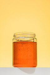 Golden floral honey in a jar on the podium. Organic and healthy.