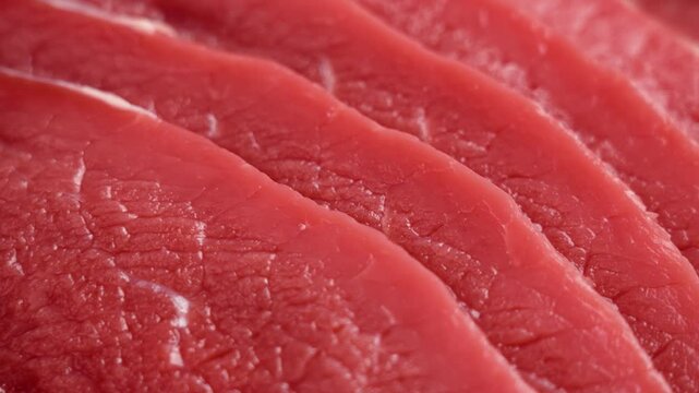 Raw beef escalope. Thinly sliced ​​fresh red meat steak. Close up. Rotation
