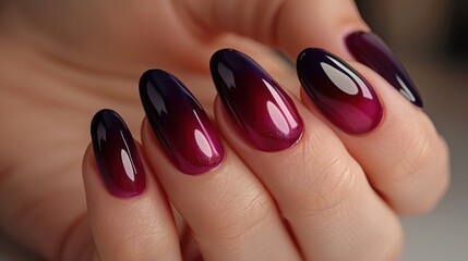 Elegant woman s hand with deep berry and plum nail polish, gel manicure at a luxury beauty salon