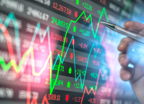 Hand of advisor checking stock market data on screen