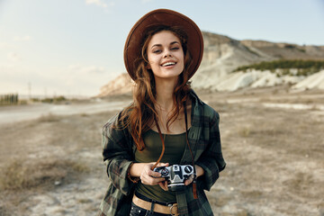 vintage vibes woman in plaid shirt and hat capturing the desert with old camera