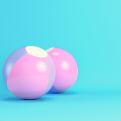 Pink inflatable beach balls on bright blue background in pastel colors