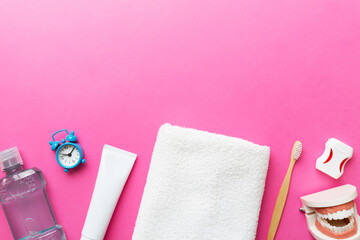 Mouthwash and other oral hygiene products on colored table top view with copy space. Flat lay....
