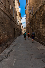 Siena, Italy - June 01, 2024: Narrow street of Siena