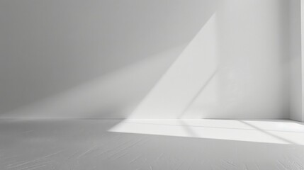 A sunbeam casts a shadow on a white wall