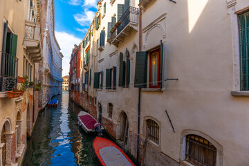 Venice, Italy - June 03, 2024: Peaceful Venice Canal with Docked Boats.