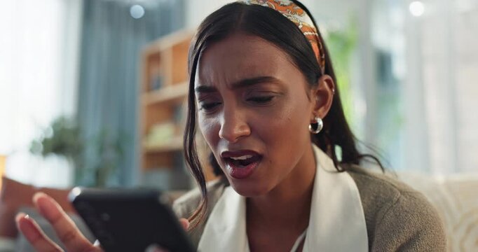 House, woman and shocked with smartphone for scam or cybercrime on fake website. Female person, sofa and frustrated at living room with internet or online fraud and hacking of social media profile